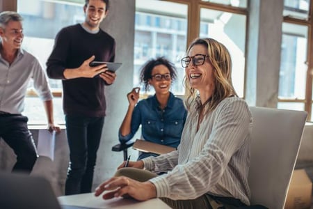 Business group smiling during a meeting - Business Services